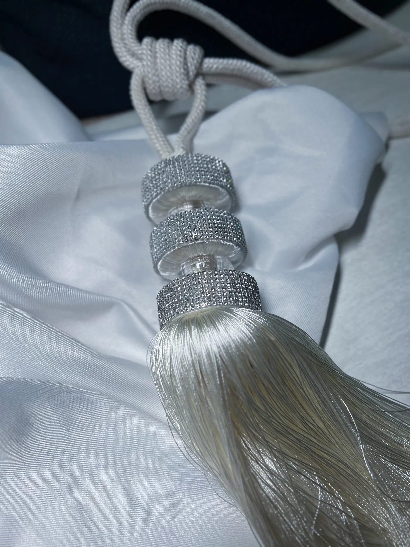 Pingente de cortina com detalhes em strass sobre tecido claro